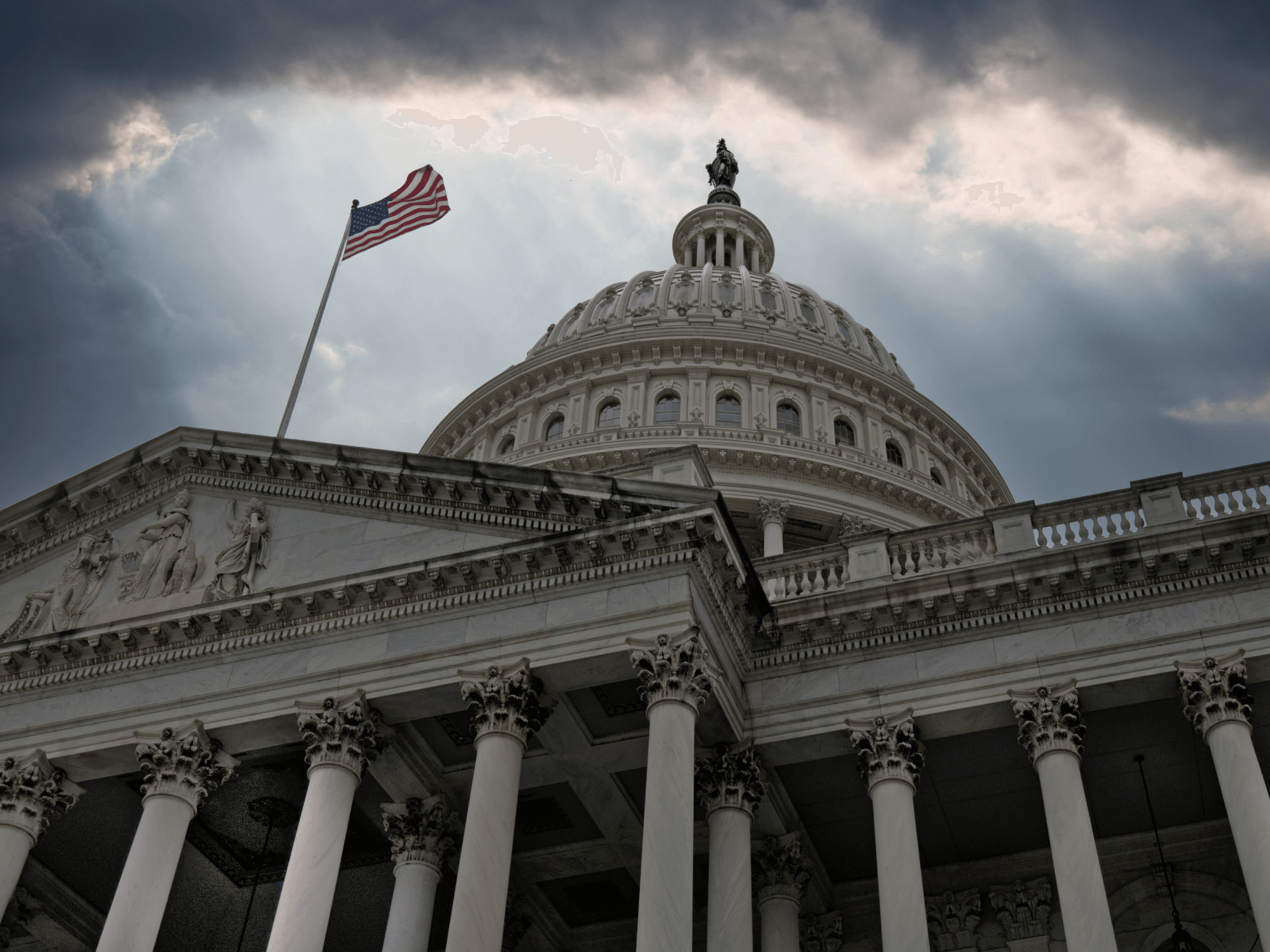 Low angle image of the US Federal Reserve building with clouds overhead